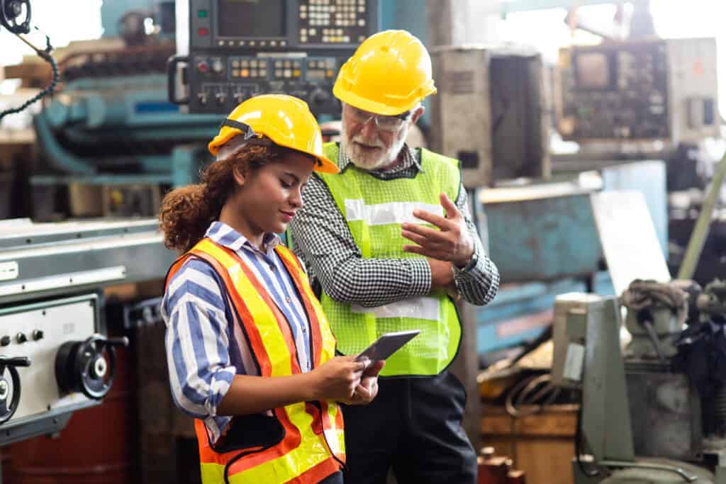 manufacturing team reviewing data on tablet